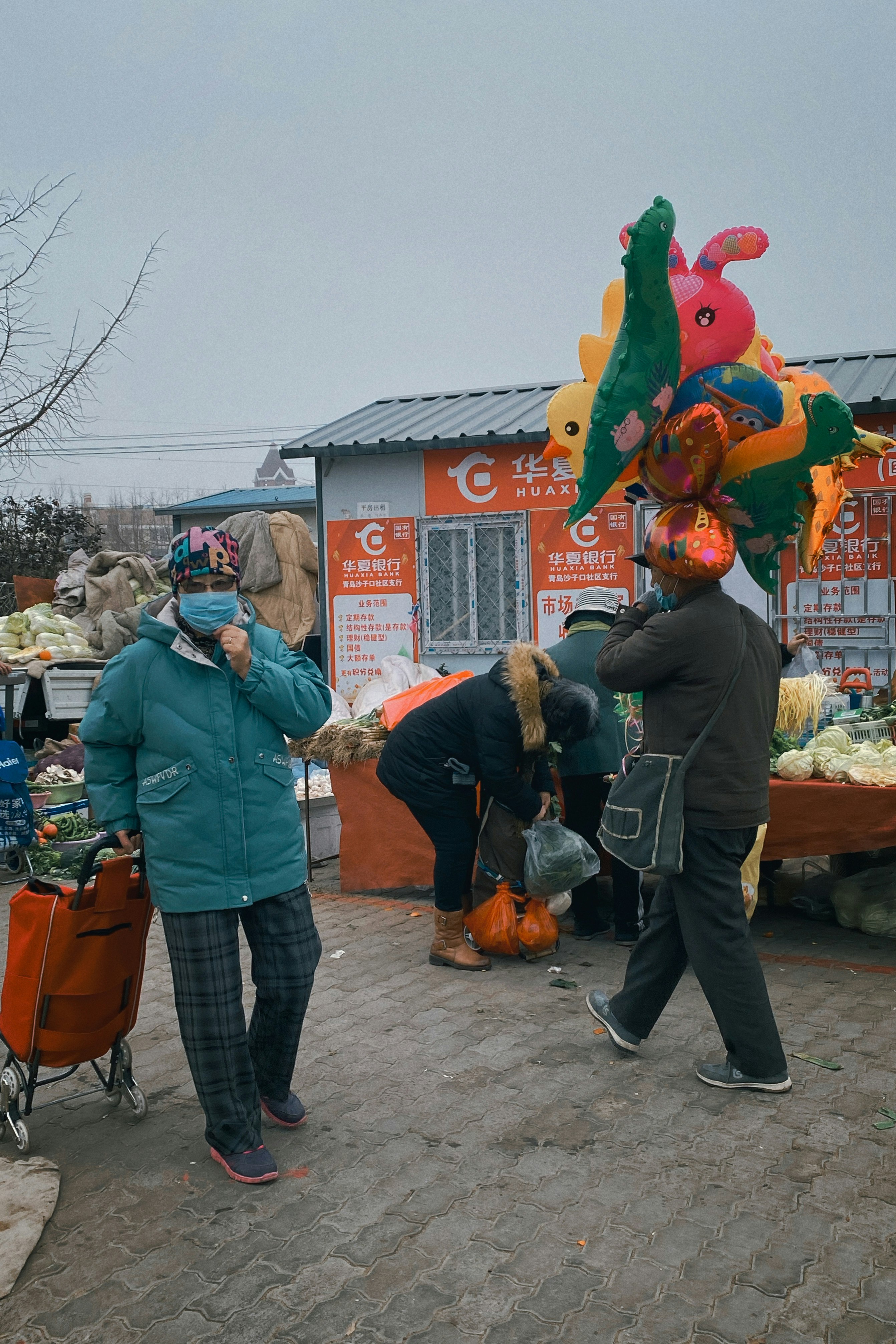 people standing near red and green animal mascot during daytime